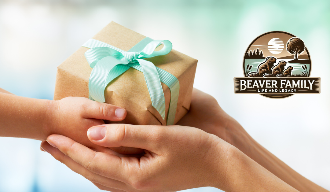 A close-up image of a child’s hands giving a gift wrapped with a teal ribbon to an adult’s hands, symbolizing the concept of giving and legacy, with the Beaver Family Life and Legacy logo on the right.